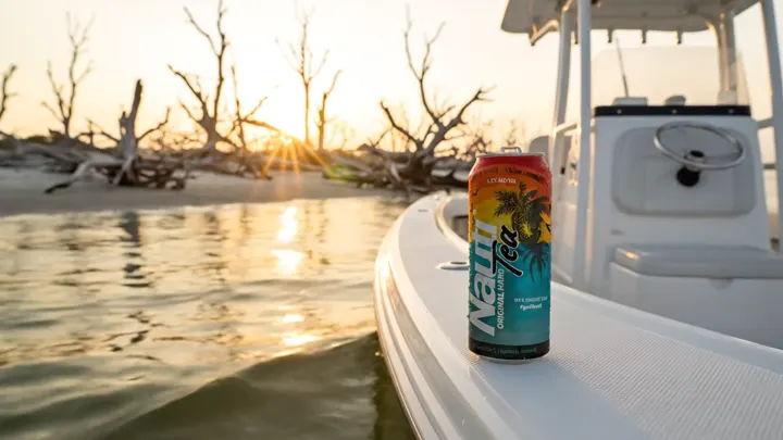 A can on the gunwale of an anchored boat at golden hour